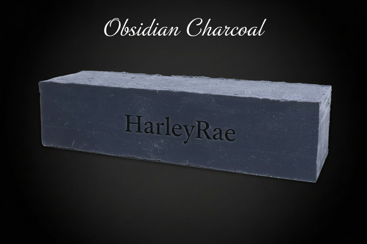 Obsidian charcoal bar of soap with 'HarleyRae' branding on a black background